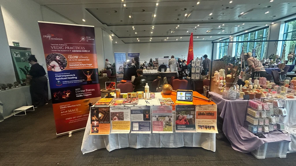 market stall with event poster, books, feedback form, gada and nandi products